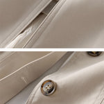 Beige Windbreaker-Detail mit Knopfverschluss und sauberer Naht