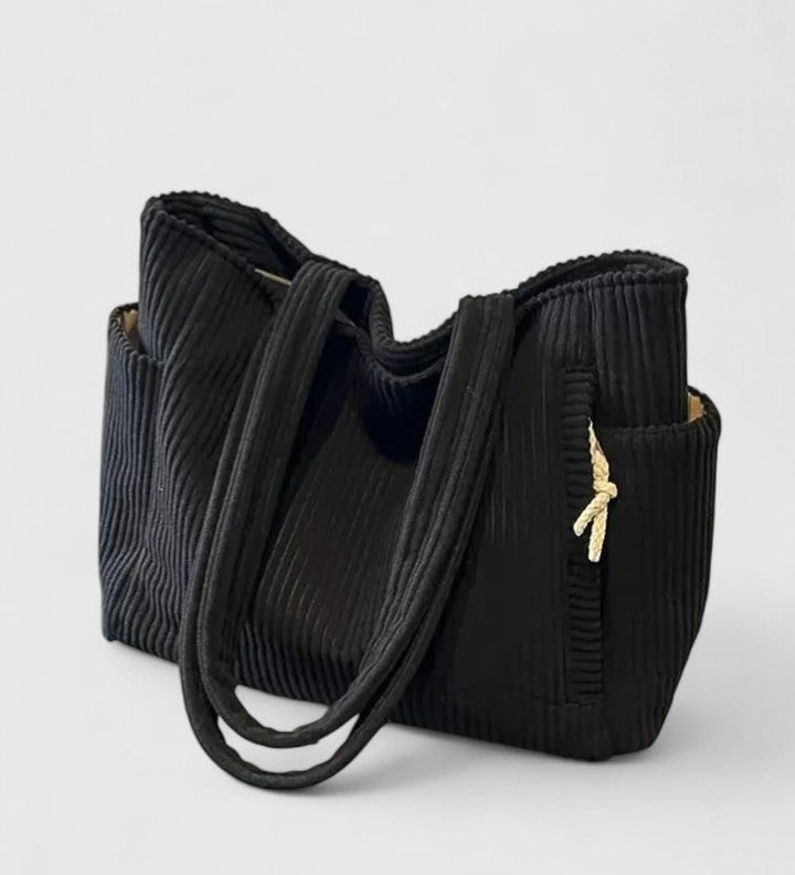 Schwarze Shopper-Tasche aus geripptem Cord mit Tragehenkeln und goldenem Zugband