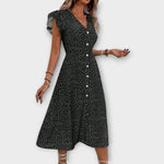 Schwarzes Midi-Kleid mit Polka-Dots, V-Ausschnitt, Knopfleiste, Glockensaum und seitlicher Schlitz