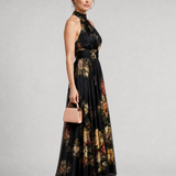 Schwarzes Halter-Neck Midi-Kleid mit floralen Prints, seitliche Ansicht, weiter Rock