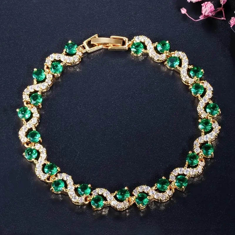 Goldfarbenes Armband mit grünen und klar funkelnden Steinen, Gliederkette