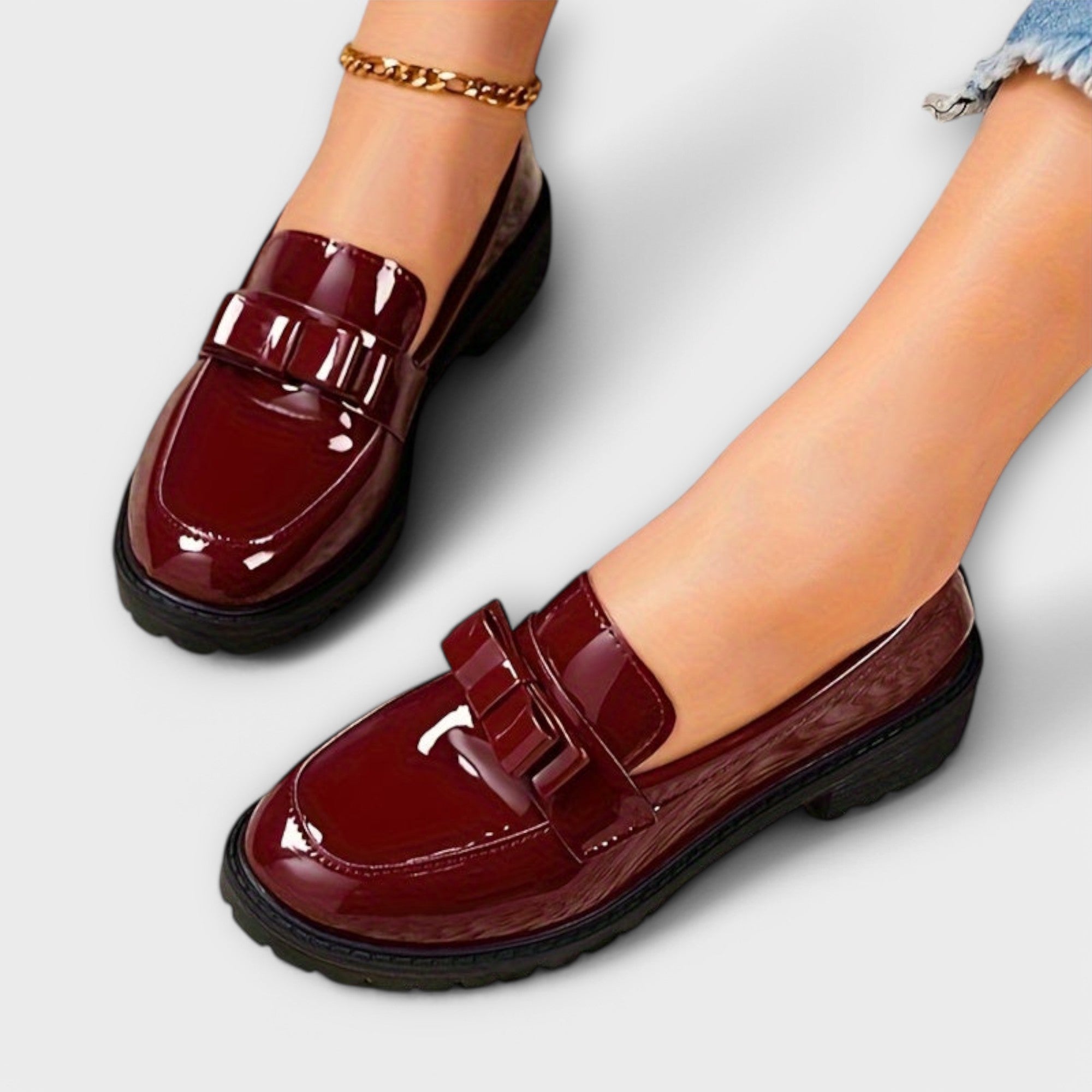 Bordeauxfarbene Loafer aus glänzendem Material mit Zierschnalle vorne und Blocksohle