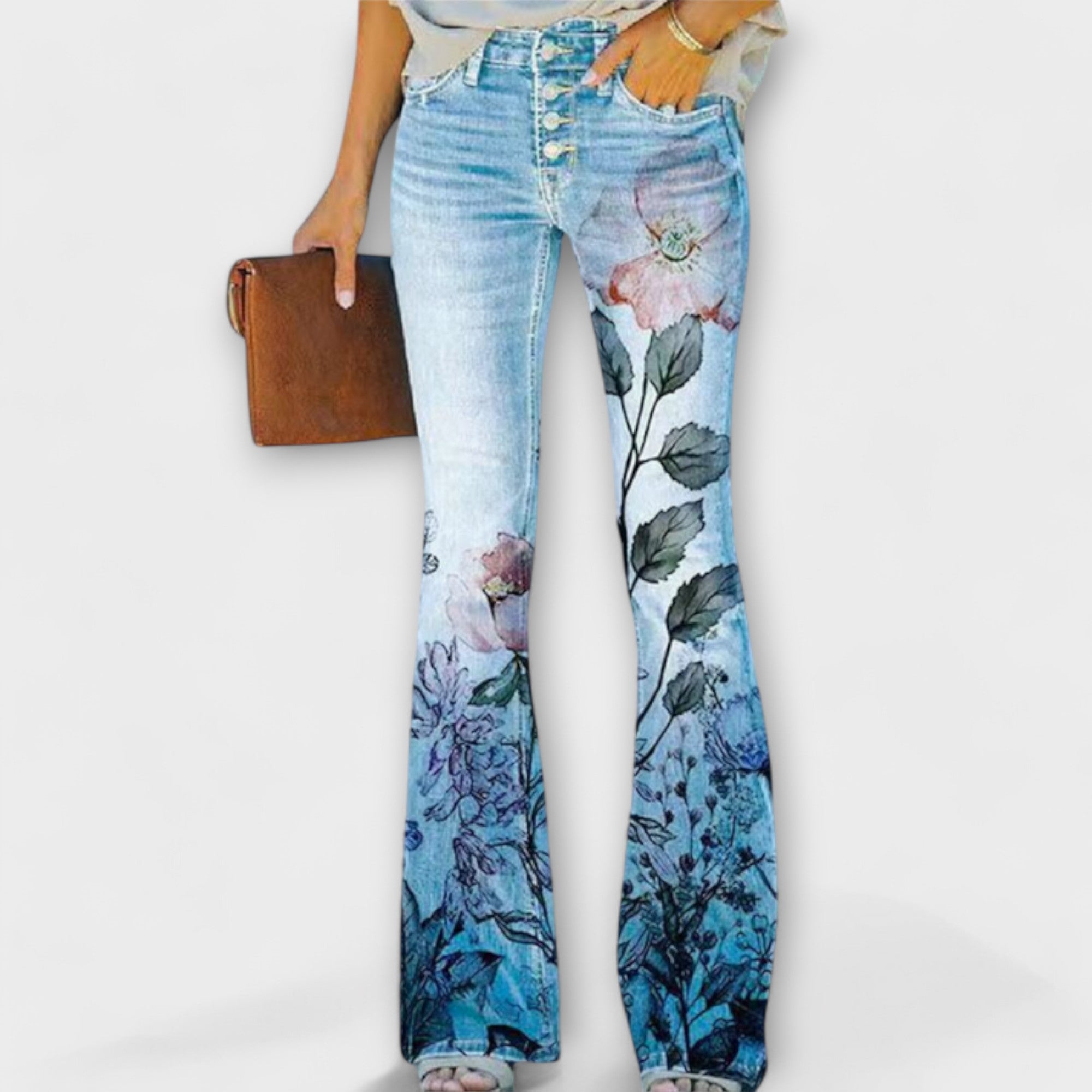 Jeanshose mit weitem Bein, großflächiger Blumenprint in Blau- und Rosatönen über den Beinen.