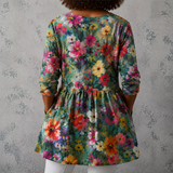 Lange Leinenbluse in Rückenansicht mit buntem Blumenmuster und geraffter Taille