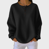 Schwarzer Pullover aus Waffelstrick mit Knopfleiste am Halsausschnitt