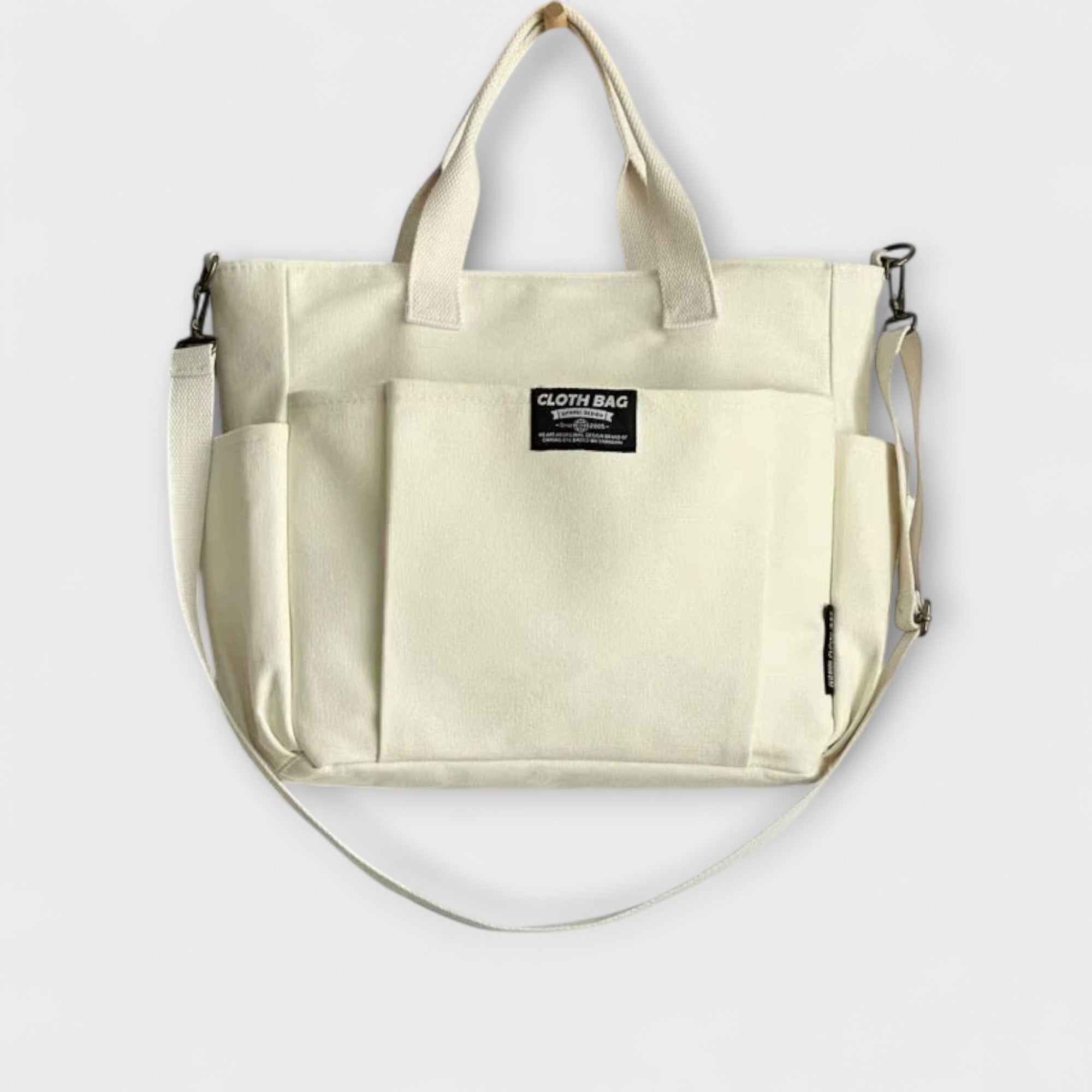 Weiße Canvas-Totebag mit Fronttasche, Tragegriffen und Schulterriemen