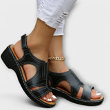 Orthopädische Ledersandalen in Schwarz mit Knöchelriemen, Kette und breitem Absatz