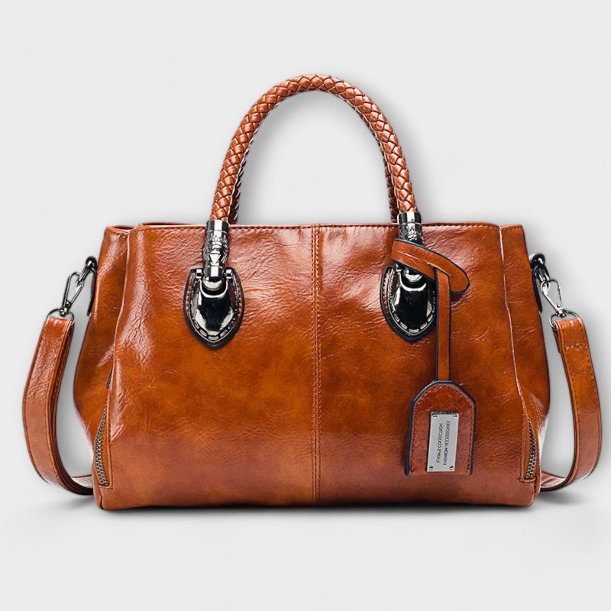 Reisetasche aus braunem Leder mit geflochtenem Tragegriff und abnehmbaren Schulterriemen