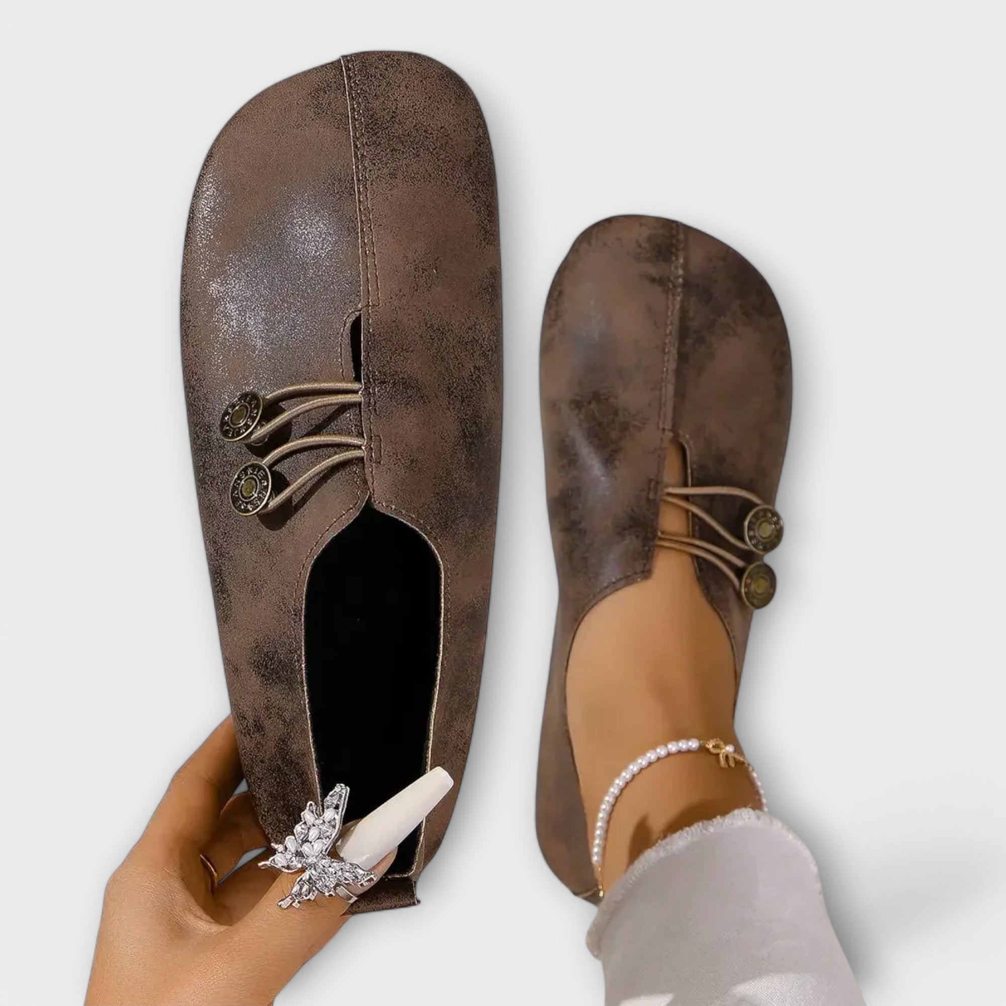 Dunkelbraune Slipper mit Schnürung und goldfarbenen Zierknöpfen, weiche Oberfläche