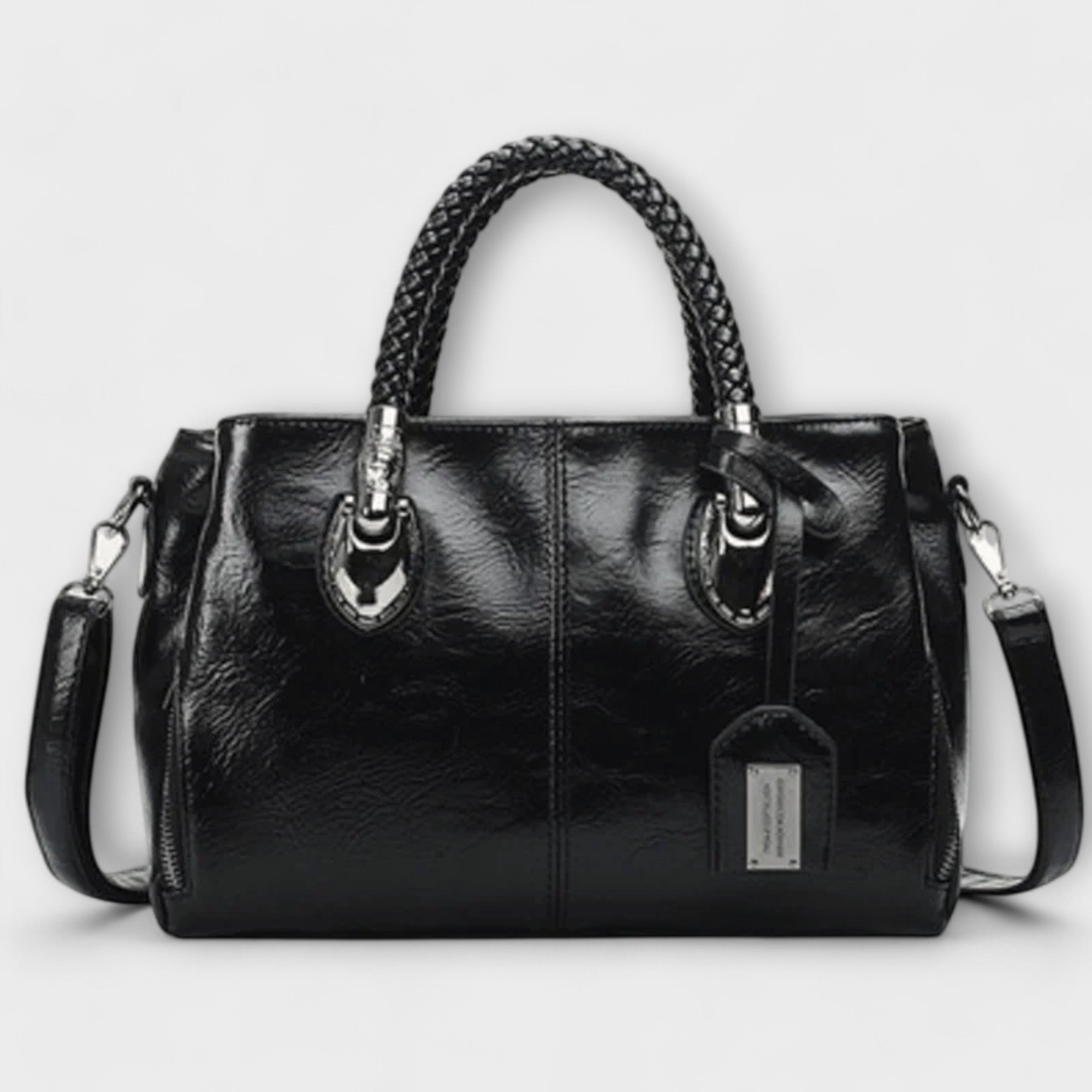 Reisetasche aus schwarzem Leder mit geflochtenem Tragegriff, zwei Schnallen und Schulterriemen