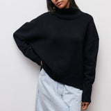 Schwarzer Rollkragenpullover mit geripptem Stehkragen und langen, breiten Bündchen.