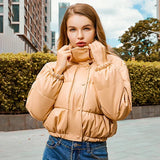 Beigefarbene Bomberjacke mit wattierter Steppung, Knopfleiste und Stehkragen.