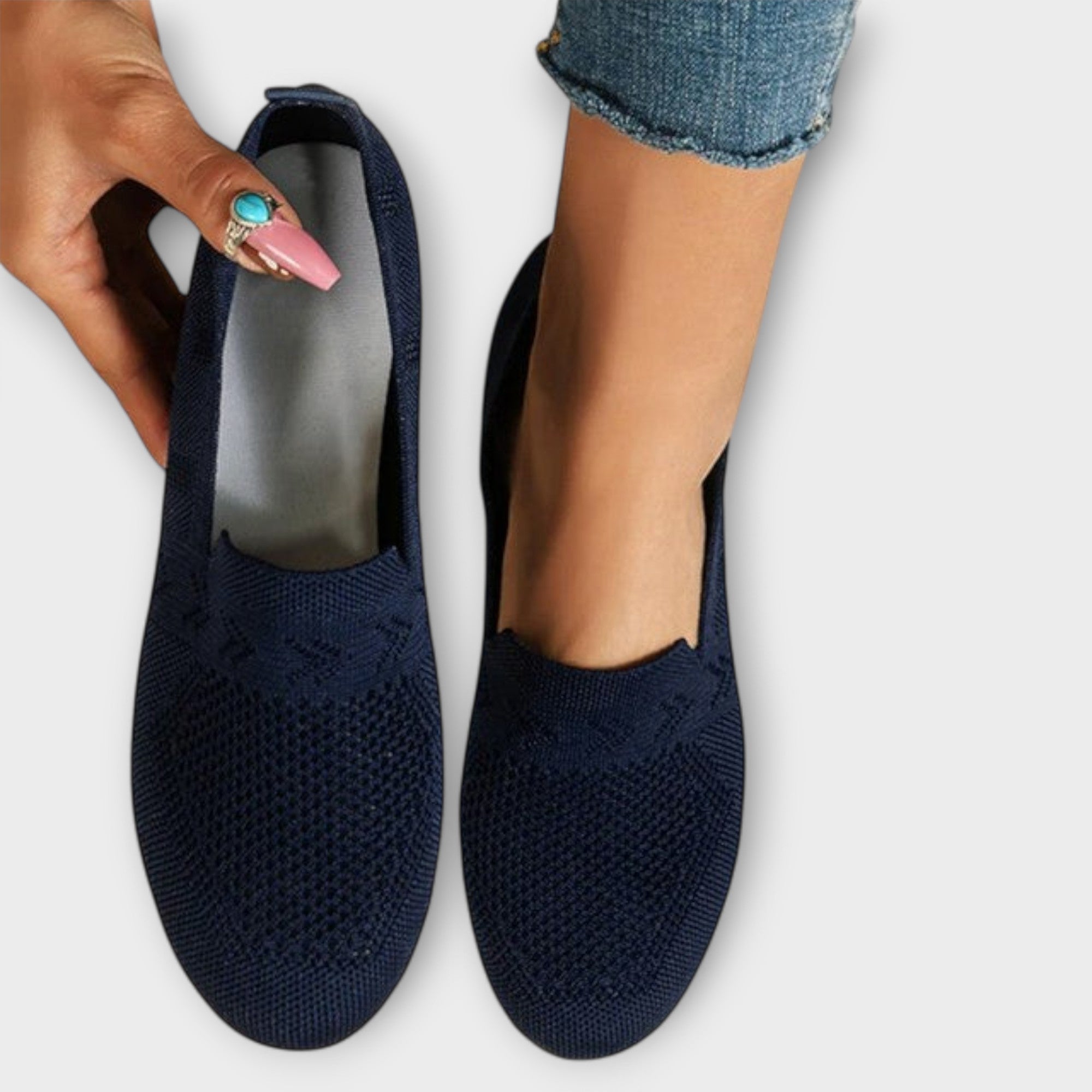 Jasz-Vielseitige Loafer dunkelblau mit Lochmuster, Hand hält einen Schuh