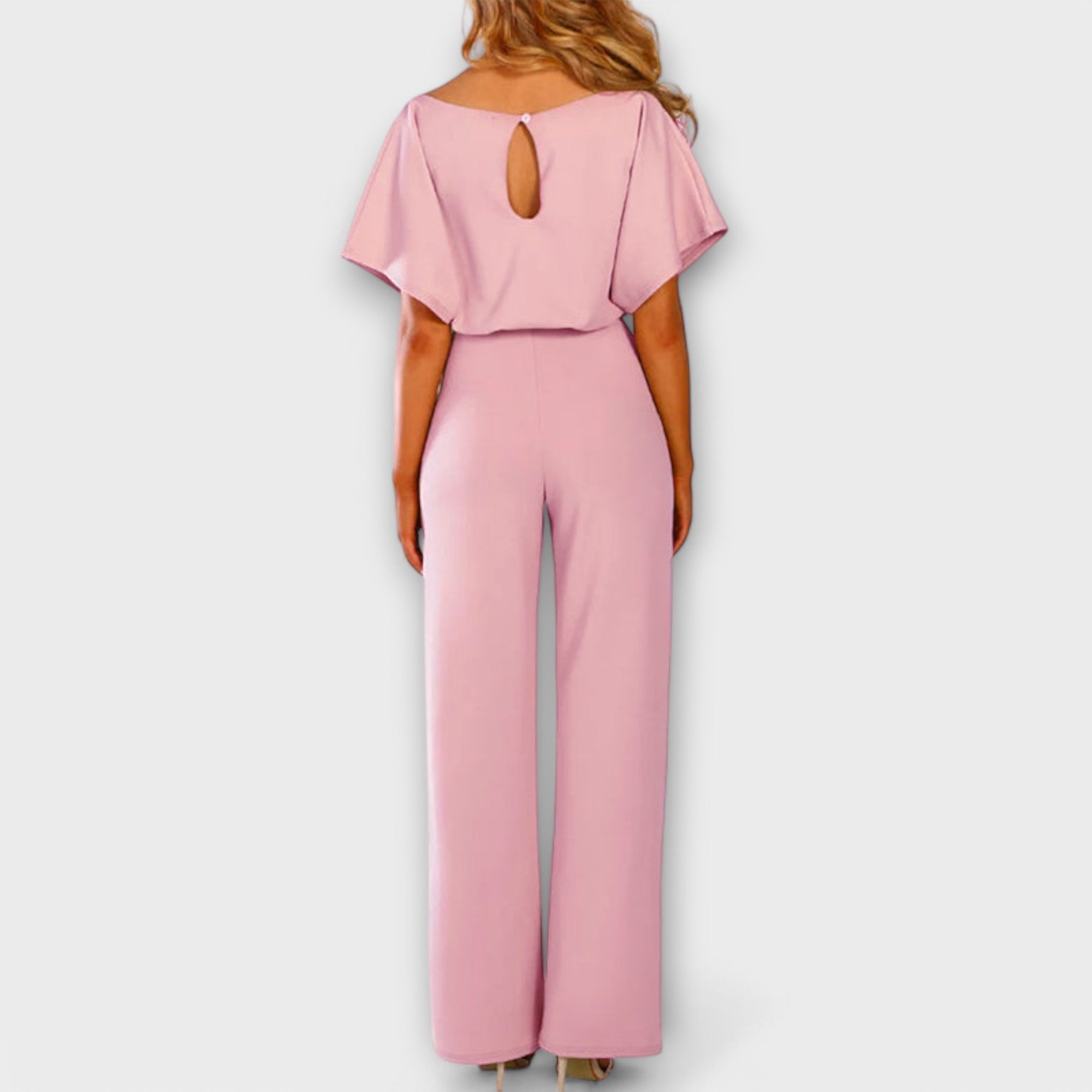 Rosa Jumpsuit in Rückansicht mit Cut-out am Rücken, weite Hosenbeine und Bindebund