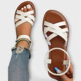 Weiße Sandalen mit gekreuzten Riemen und offener Zehenpartie, flache Sohle