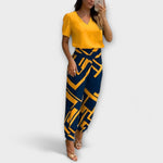 Elegantes Set mit Oberteil und Hose, gelbes Oberteil und dunkelblaue Hose mit Grafikmuster