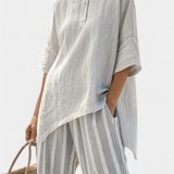 Asymmetrische Bluse mit Knopfleiste und gestreifter, weiter Hose in Hellgrau