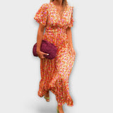 Maxikleid mit V-Ausschnitt und geraffter Taille, buntem Blumenprint (orange) von vorn